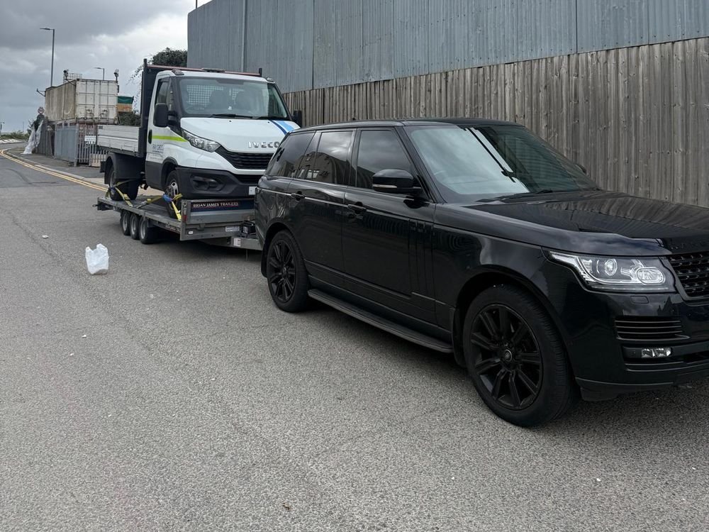Iveco tipper truck loaded on a car trailer
